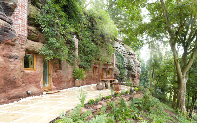 Exterior view of the Grand Designs cave house, which is perched on a rocky hillside