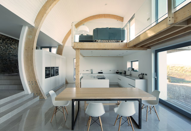 Interior of the Grand Designs blacksmith's forge showing the open-plan layout and mezzanine level