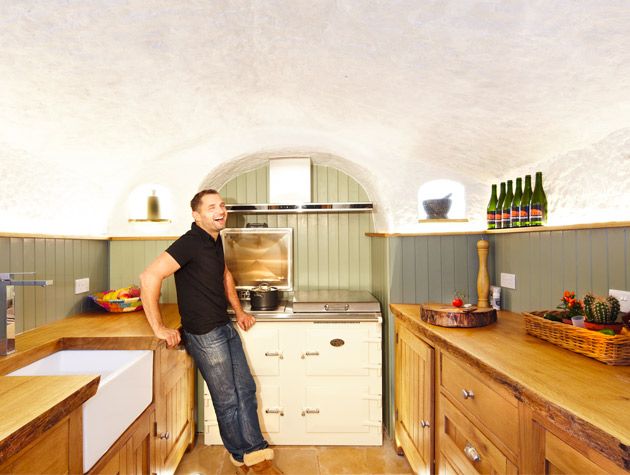 Angelo stands in the kitchen of the Grand Designs cave house