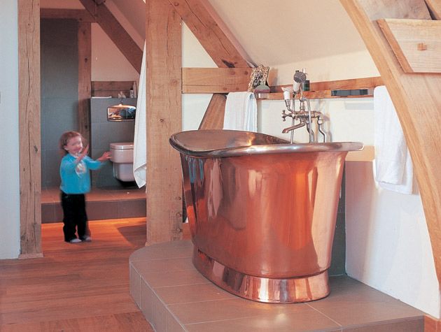 Copper freestanding bath in the Hampshire Dairy Cottage from Grand Designs 