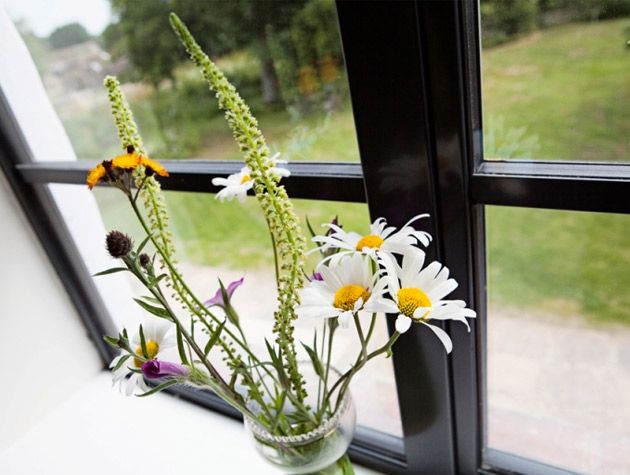 vase with flowers on window seal