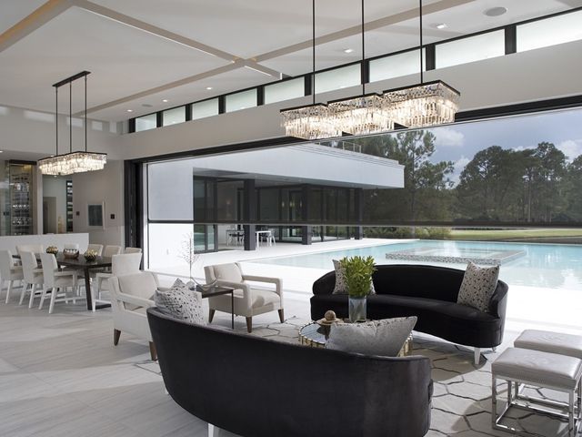 phantom screens large power screen in a modern open plan living area with black sofas, minimalist decor