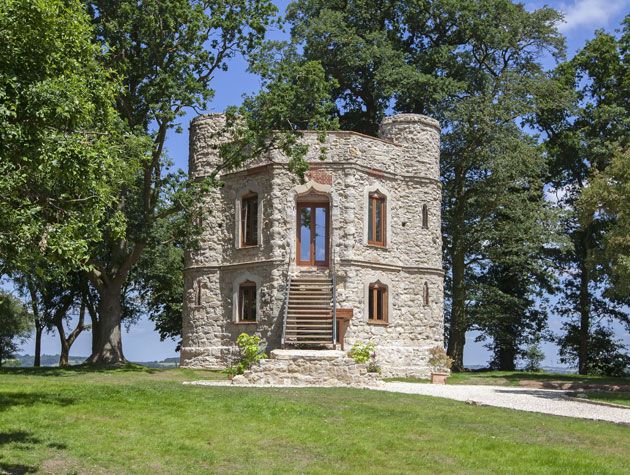 Brickwork folly like castle surrounded by trees and greenery -tv-houses-granddesignsmagazine.com