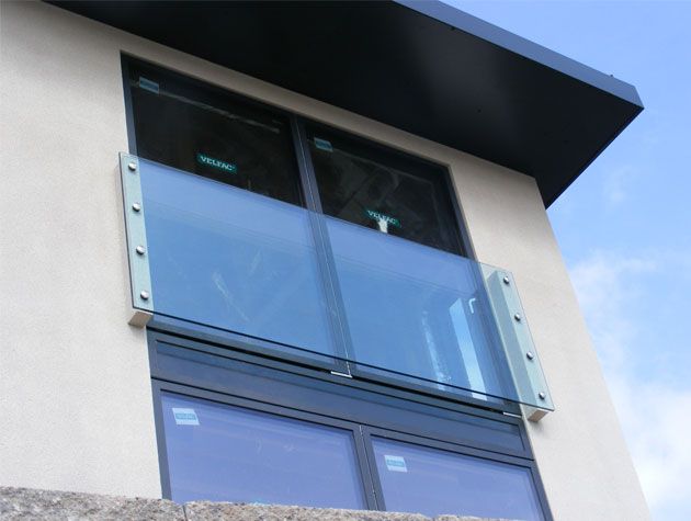 Glass window with glass balcony white building balconylife-home-improvements-granddesignsmagazine.com