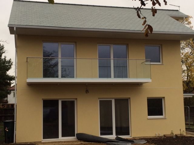 Magnolia coloured house with glass balcony at the front of the house balconylife-home-improvements-granddesignsmagazine.com