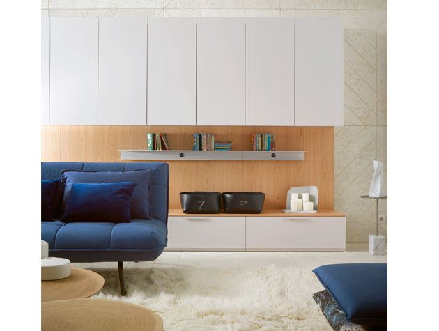White built-in cupboards in living room with blue sofa and fluffy white rug -ligne-roset-home-improvements-granddesignsmagazine.com