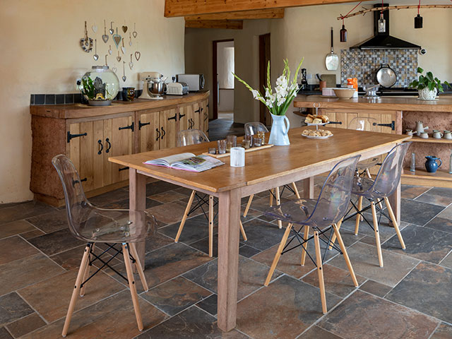 Tiled floor with wooden table and chairs in farmhouse style kitchen