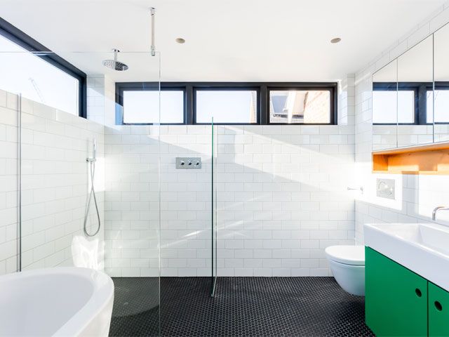 White tile bathroom with clerestory windows and solar control coating id-systems-improvements-granddesignsmagazine.com