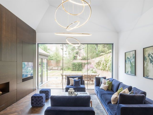 A living room with blue sofas and a circular light -gpad-london-ltd-home-improvements-granddesignsmagazine.com