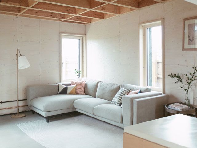 a pale grey sofa in the living room of u build box house featured on Channel 4's My Grand Design, designed by Studio Bark
