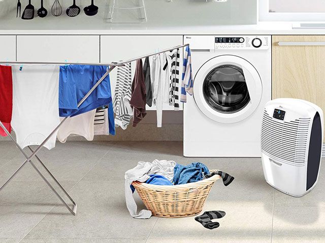 Dehumidifier in kitchen next to drying laundry