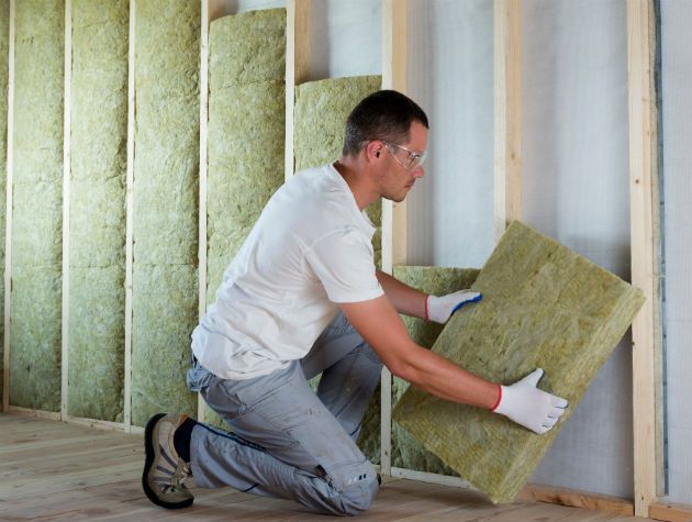 Man installing wall insulation - rockwool grand designs august 2019 