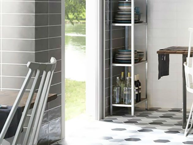 A tiled dining room opening out onto a garden and river