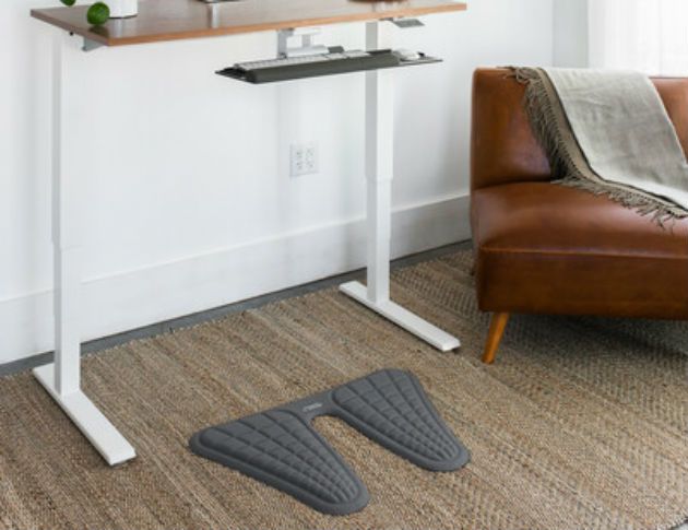 Grey geometric wall tiles and a yellow wire frame chair