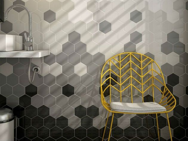 Grey geometric wall tiles and a yellow wire frame chair copy