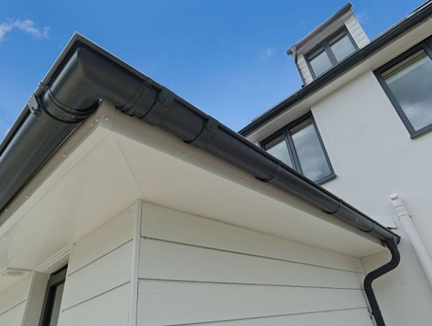 White housewith grey steel gutters