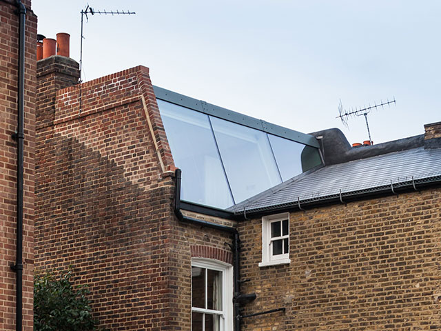 Loft extension with flat roof and wall-to-wall glazing by Browning Architects
