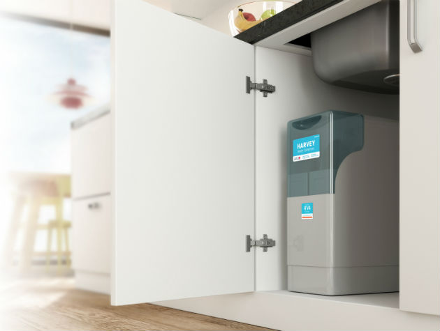 a harvey water softening unit in a kitchen cupboard