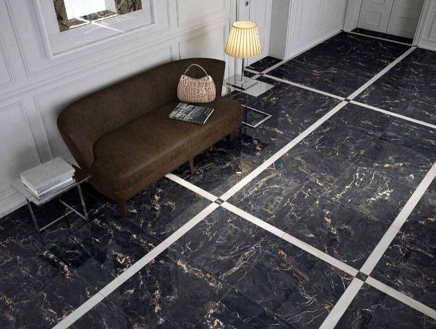 hallway of home with brown sofa lamp and black tiles