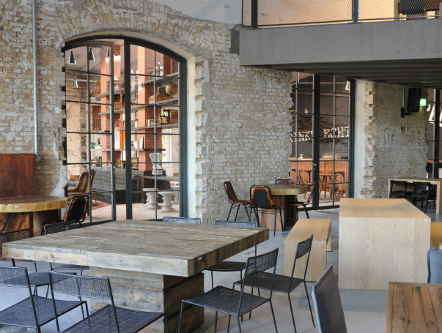 industrial chic seating area with tables chairs and steel doors