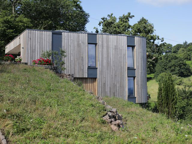 timber clad self build house on a hill - grand designs 