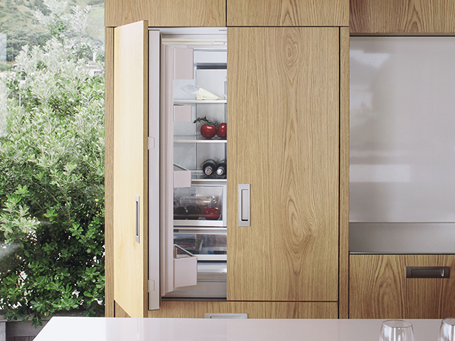 oak kitchen with integrated fridge from fisher paykel - hahei house by studio2architects - self build - grand designs 