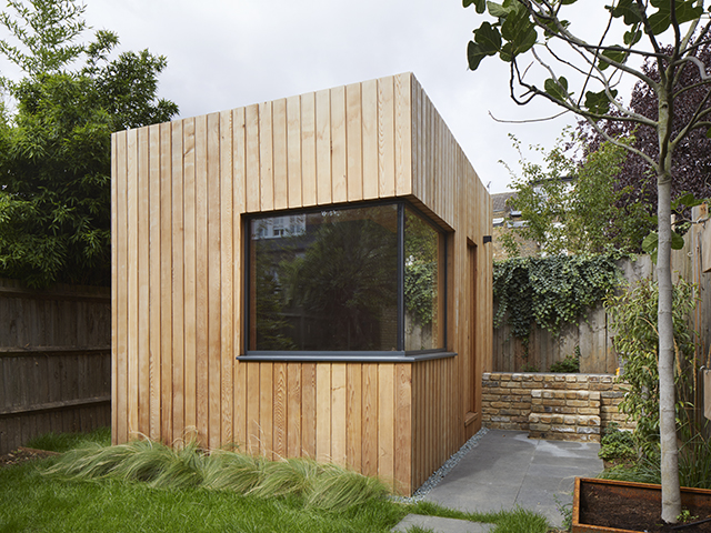 Wooden garden office building with window by RISE Design Studio