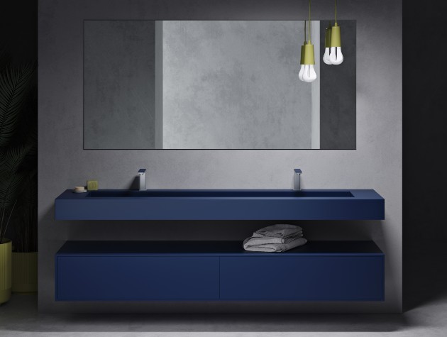 blue sink and vanity unit in bathroom with mirror