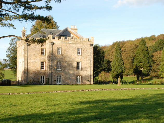 stately home set among trees and fields