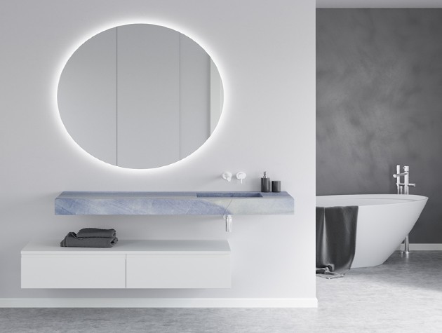 stylish modern bathroom with circular mirror and marble washbasin