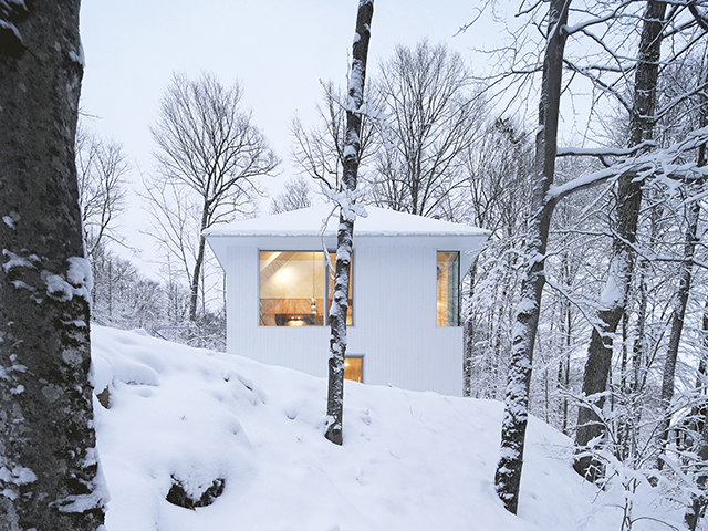 Lac Poisson Blanc white chalet cabin in snowy landscape - self build - grand designs
