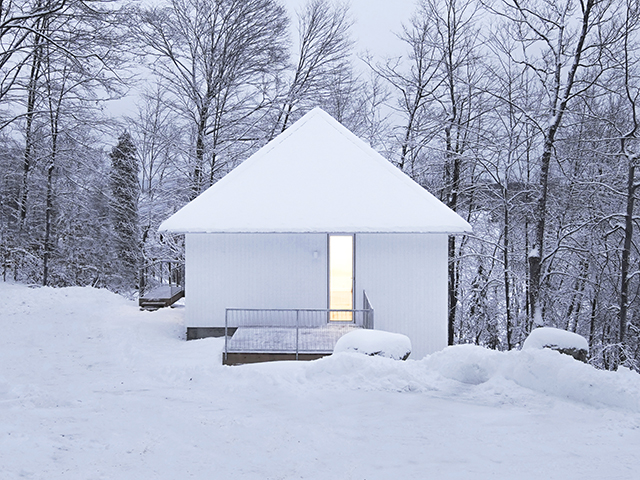 Lac Poisson Blanc white chalet cabin in snowy landscape - self build - grand designs