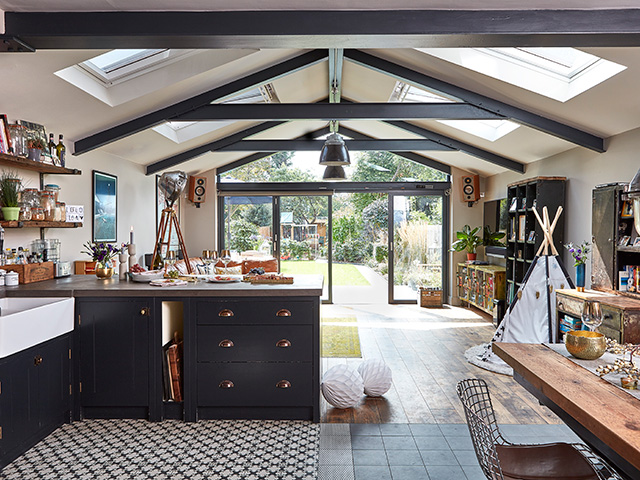 Kloeber Aluminium Bifolds in contemporary kitchen with exposed roof gables - grand designs