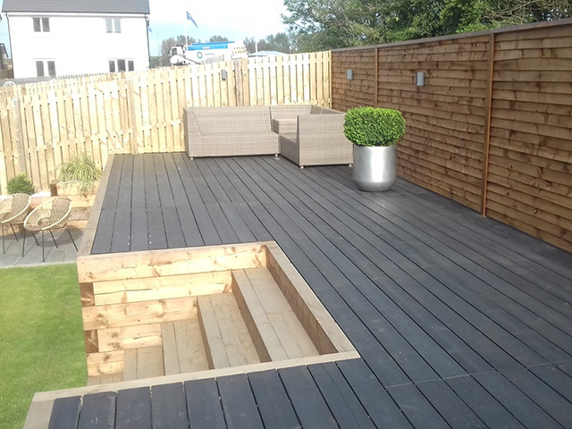 garden with steps up to a decked area - grand designs