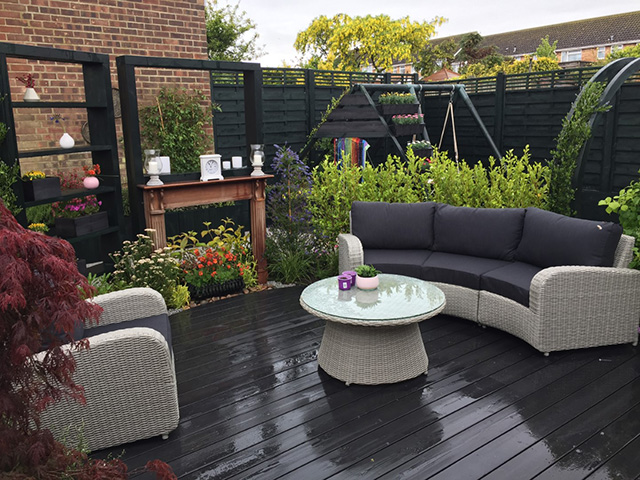 dark black timber iro decking in a modern garden - grand designs