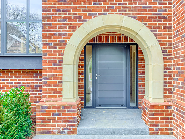 modern aluminium door on traditioal brick house - grand designs - self build