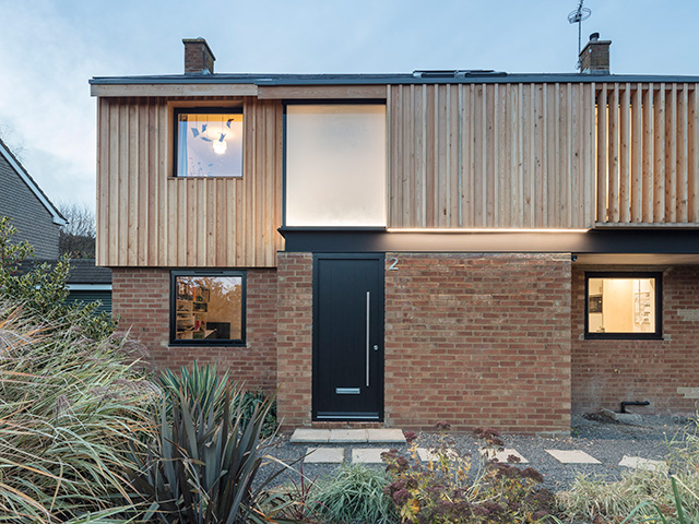 black front door on contemporary cladded home - grand design - self build
