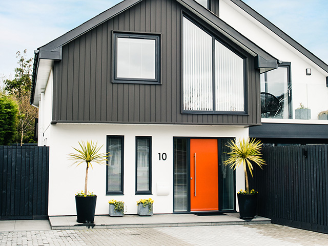 modern house with bright orange front door - self build - grand designs 