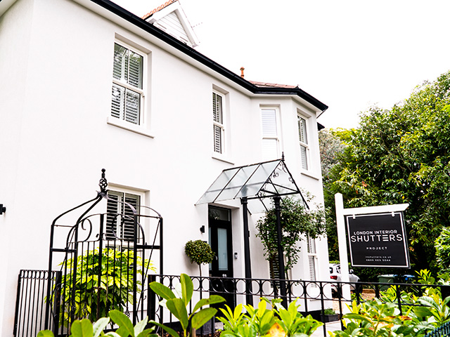 house painted white with interior shutters and wrought iron fencing - home improvements - grand design