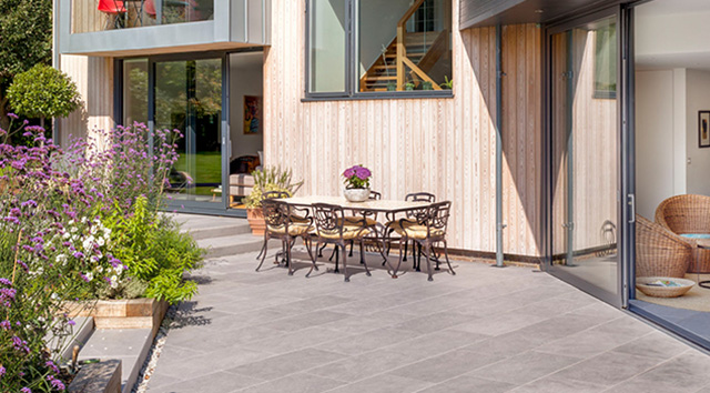 tiled patio with flowers and dining table