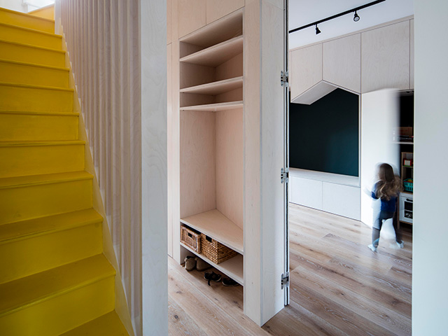 hallway with yellow stairs leading onto children's playroom - extensions - grand designs