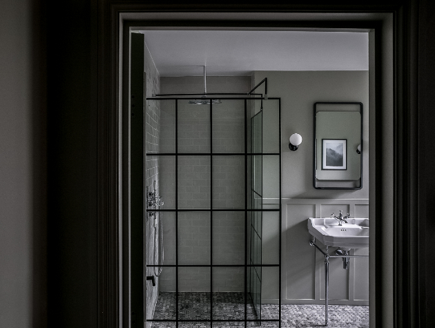 bathroom seen through a doorway with walk in shower