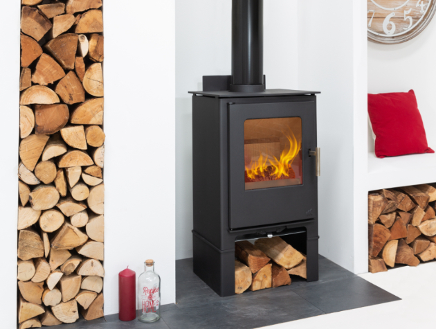 black stove fire with long chimney and log store