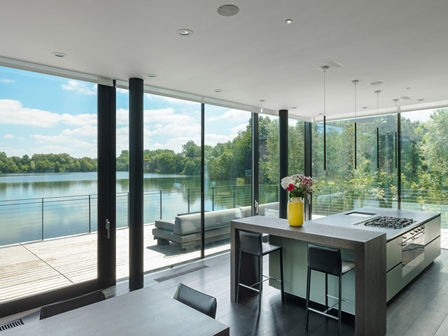 large house on shore of lake in cotswolds - self build homes - grand designs