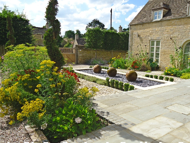 landscaped garden with paving and plants