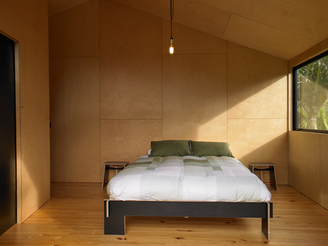 minimalist bedroom - discover this spectacular beach-front cabin in New Zealand - self build homes - granddesignsmagazine.com