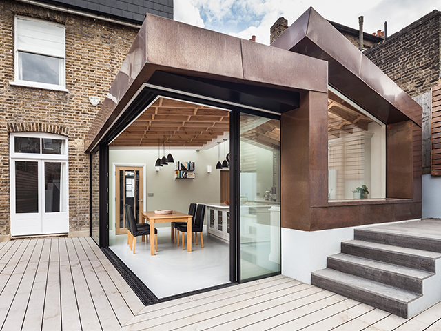 This copper-clad kitchen extension by UV Architects makes the most of limited external space by allowing the kitchen to into the garden