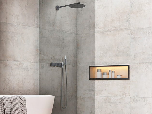 walk in shower with large tiles next to bathtub