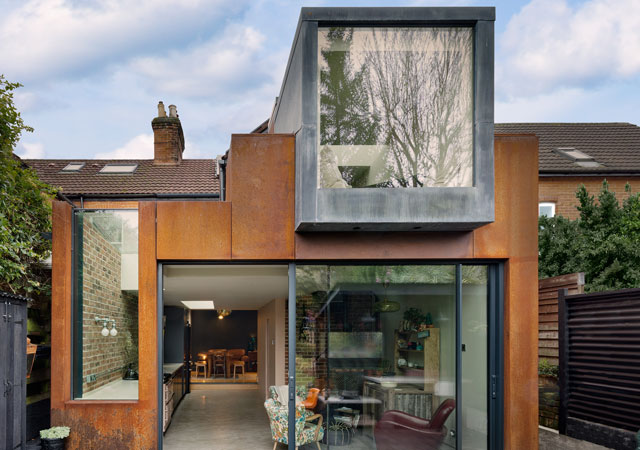 Rear exterior of a corten steel clad extension to a victorian house