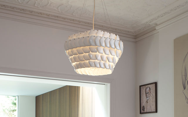 A hexagonal shape ceiling pendant light made from overlapping bone china discs